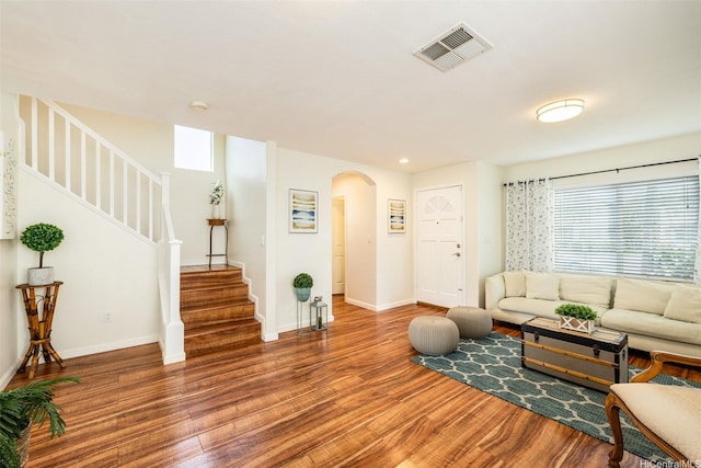 91-6414 Kapolei Pkwy, Ewa Beach, HI 96706 - living room featuring arched walkways, wood finished floors, stairs, baseboards, and recessed lighting