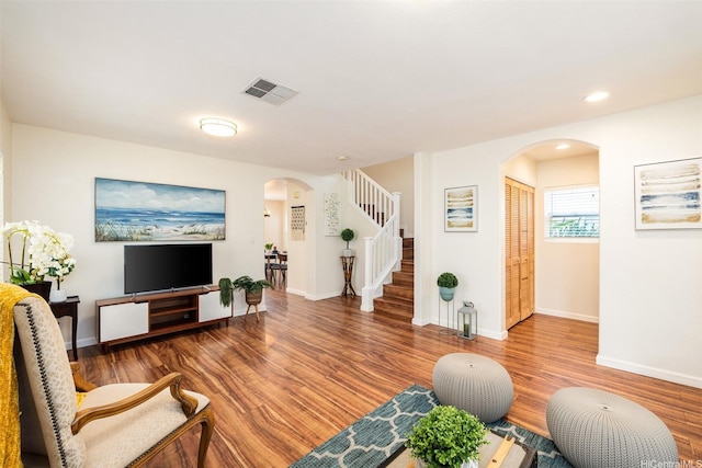 91-6414 Kapolei Pkwy, Ewa Beach, HI 96706 - living area with arched walkways, stairs, wood finished floors, baseboards, and recessed lighting