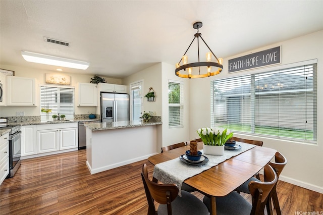 91-6414 Kapolei Pkwy, Ewa Beach, HI 96706 - dining area featuring a chandelier, baseboards, and wood finished floors