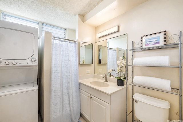 1805 Poki St Unit 1101, Honolulu, HI 96822 - full bath with stacked washing machine and dryer, vanity, toilet, a textured ceiling, and a shower with shower curtain