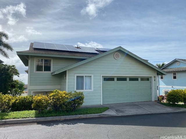 92-7049 Elele St Unit 71, Kapolei, HI 96707 - view of front facade featuring a garage, roof mounted solar panels, and driveway