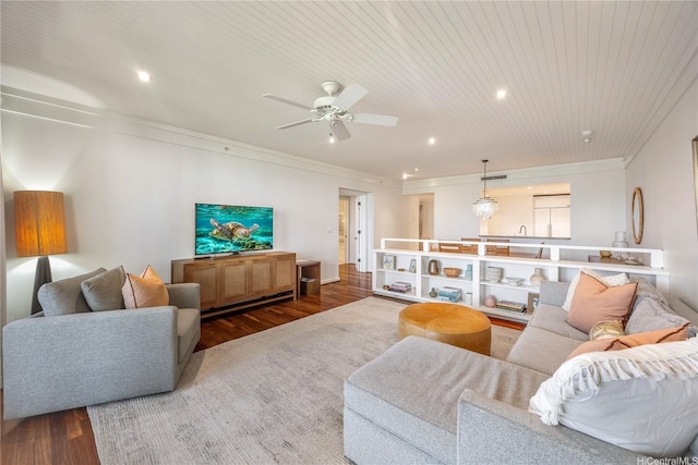 living area with crown molding, recessed lighting, a ceiling fan, and wood finished floors