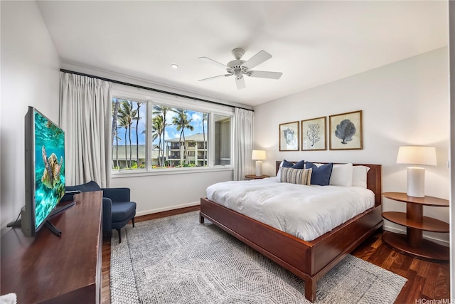 bedroom featuring baseboards, ceiling fan, and wood finished floors