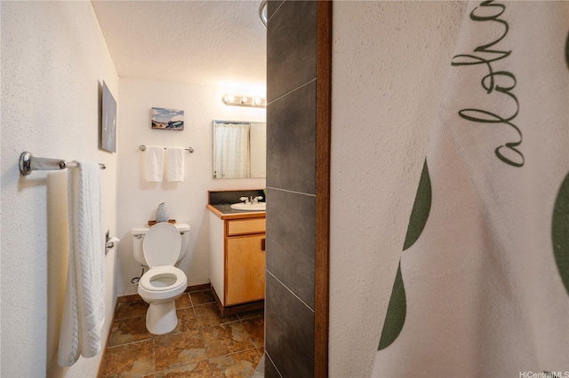 bathroom with tile patterned floors, toilet, and vanity