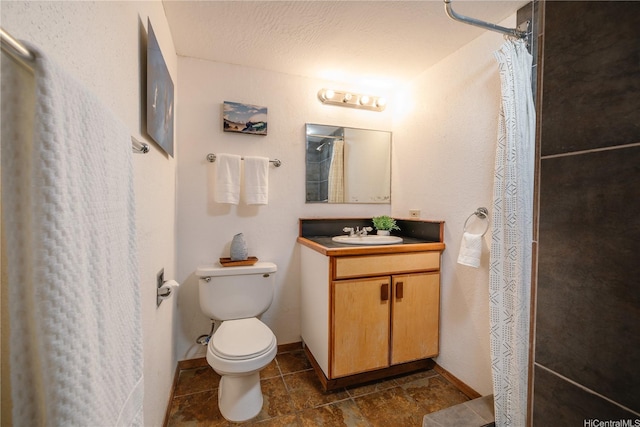 bathroom with toilet, curtained shower, baseboards, and vanity