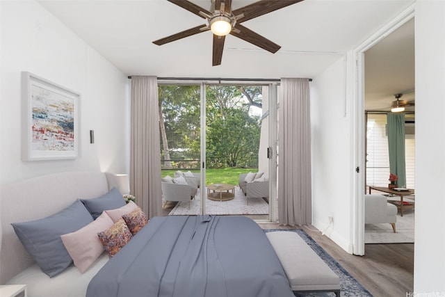 95-2027 Waikalani Pl Unit A102, Mililani, HI 96789 - bedroom featuring access to outside, wood finished floors, a wall of windows, multiple windows, and ceiling fan