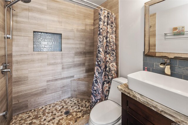 75 Kihapai St Unit 11, Kailua, HI 96734 - bathroom with tiled shower, backsplash, and toilet