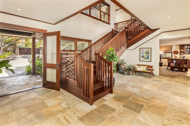 stairs featuring recessed lighting and stone tile floors