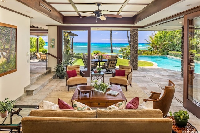 sunroom / solarium with a healthy amount of sunlight, a water view, visible vents, and stone tile flooring
