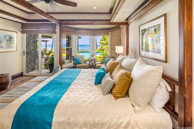 bedroom featuring recessed lighting, baseboards, a water view, wood finished floors, and access to exterior