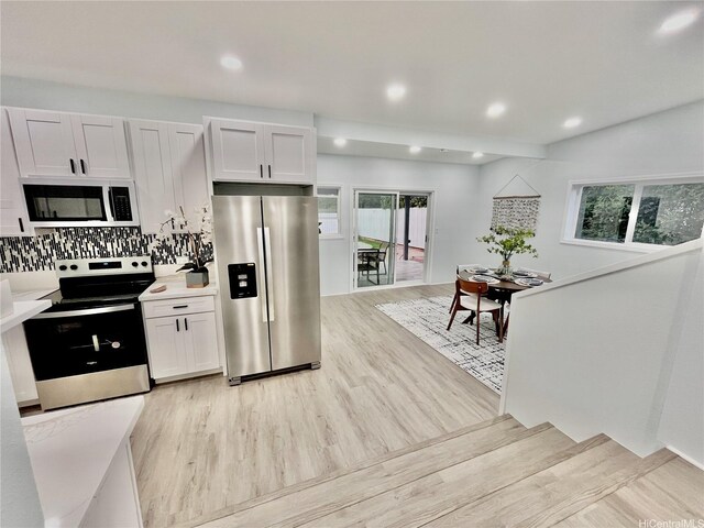 87-224 Laulele St, Waianae, HI 96792 - kitchen with stainless steel appliances, light wood-style floors, light countertops, tasteful backsplash, and recessed lighting