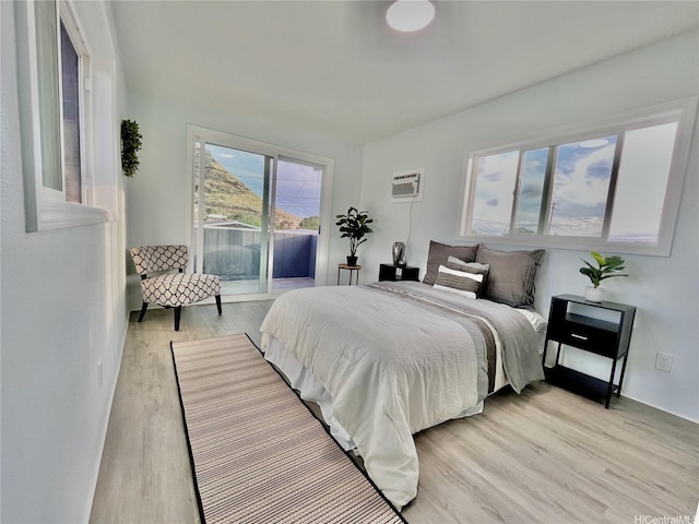 87-224 Laulele St, Waianae, HI 96792 - bedroom with access to exterior, light wood-style flooring, and an AC wall unit