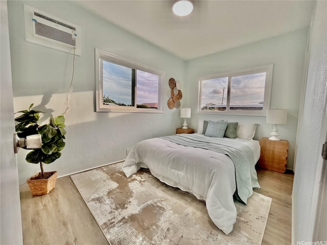 87-224 Laulele St, Waianae, HI 96792 - bedroom with multiple windows, a wall unit AC, and wood finished floors