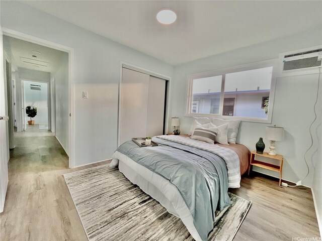 87-224 Laulele St, Waianae, HI 96792 - bedroom with a closet, an AC wall unit, and light wood-style flooring