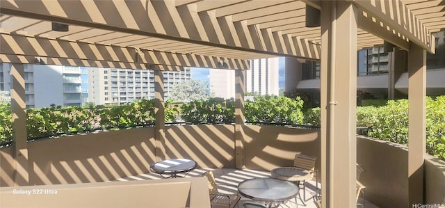 view of patio with a pergola and a balcony