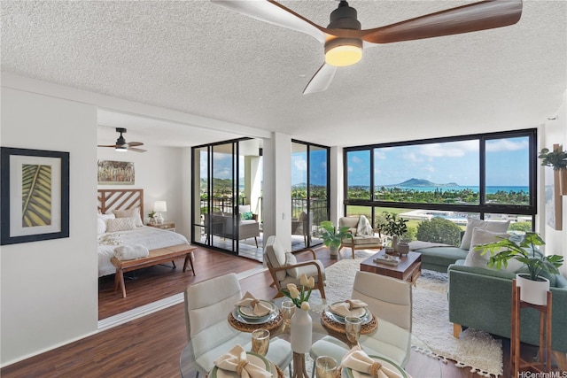 322 Aoloa St Unit 1403, Kailua, HI 96734 - living area featuring ceiling fan, a textured ceiling, wood finished floors, healthy amount of natural light, and floor to ceiling windows