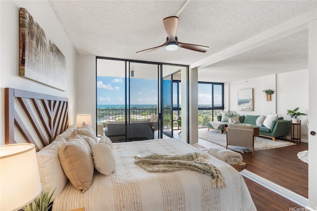 322 Aoloa St Unit 1403, Kailua, HI 96734 - bedroom featuring access to outside, a textured ceiling, wood finished floors, a wall of windows, and ceiling fan