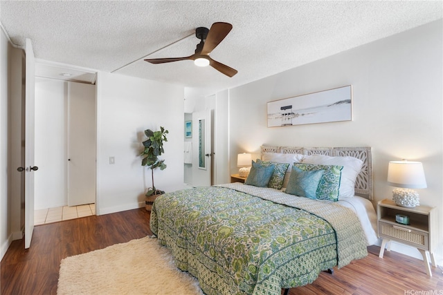 322 Aoloa St Unit 1403, Kailua, HI 96734 - bedroom with wood finished floors, a ceiling fan, a textured ceiling, and baseboards