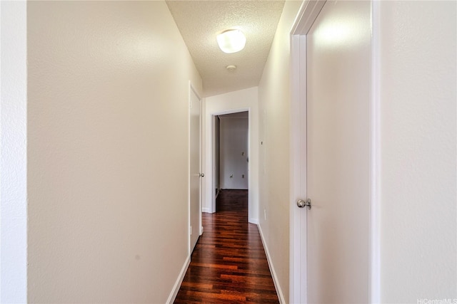 95-1059 Koolani Dr Unit 2, Mililani, HI 96789 - corridor with a textured ceiling, dark wood-style flooring, and baseboards