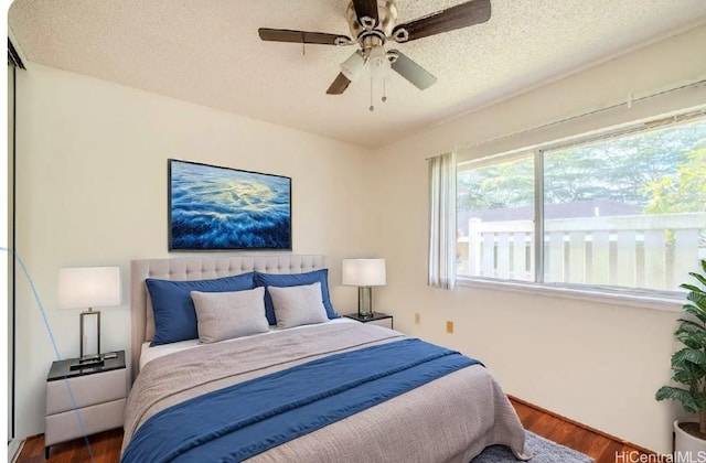95-1059 Koolani Dr Unit 2, Mililani, HI 96789 - bedroom with ceiling fan, a textured ceiling, and wood finished floors
