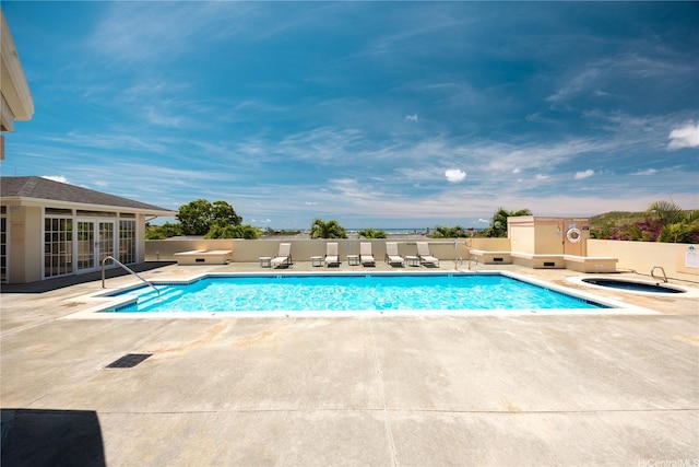 1305 Moanalualani Pl Unit 25C, Honolulu, HI 96819 - community pool with french doors, a hot tub, and a patio
