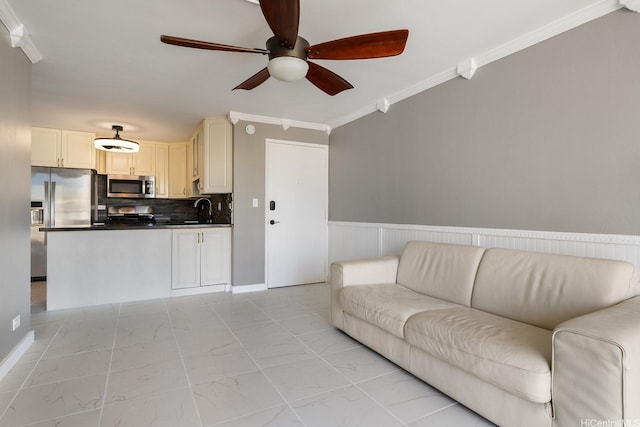 2452 Tusitala St Unit 1610, Honolulu, HI 96815 - living room with ceiling fan, ornamental molding, light marble finish flooring, and wainscoting
