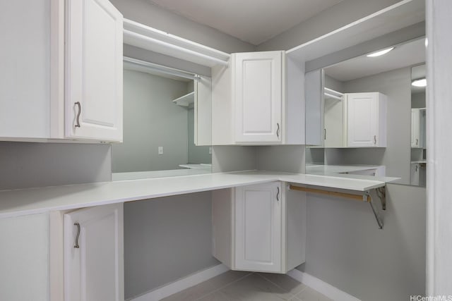 2452 Tusitala St Unit 1610, Honolulu, HI 96815 - laundry room featuring baseboards and light tile patterned floors