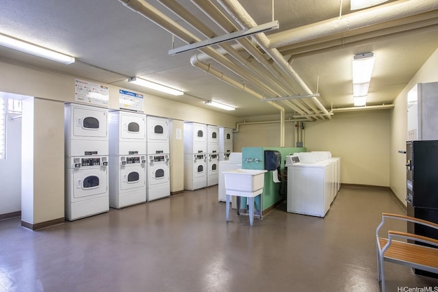 2452 Tusitala St Unit 1610, Honolulu, HI 96815 - shared laundry featuring estacked washer and dryer, washing machine and dryer, and baseboards