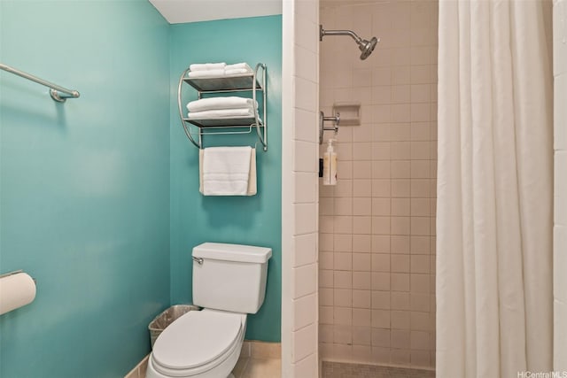 444 Kanekapolei St Unit 208, Honolulu, HI 96815 - bathroom with a tile shower, toilet, baseboards, and tile patterned flooring
