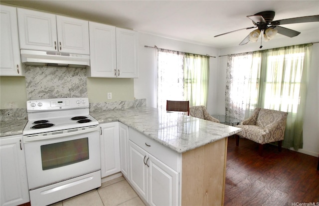 45-510 Pahia Rd, Kaneohe, HI 96744 - kitchen featuring under cabinet range hood, electric range, a peninsula, white cabinetry, and ceiling fan
