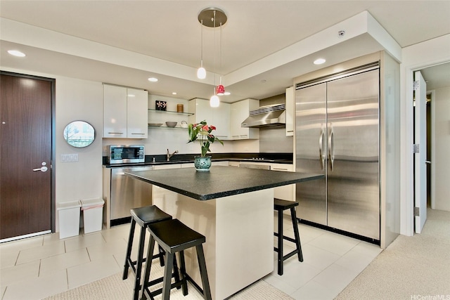 1200 Queen Emma St Unit 1104, Honolulu, HI 96813 - kitchen featuring appliances with stainless steel finishes, exhaust hood, open shelves, a sink, and dark countertops