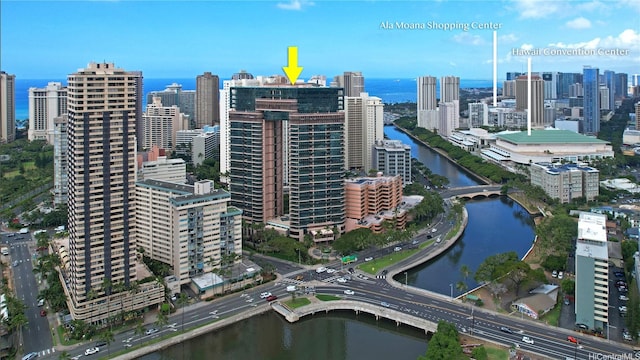 view of property location with a nearby body of water and nearby urban area