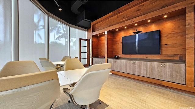 interior space featuring wooden walls and light wood finished floors