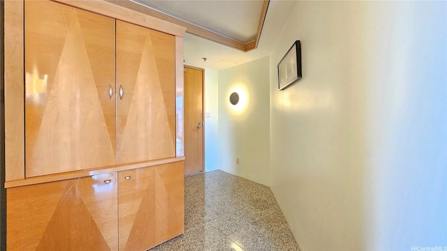 corridor featuring speckled floor