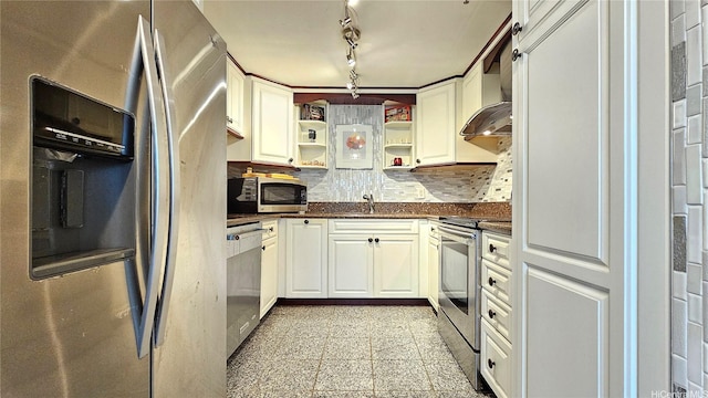kitchen featuring appliances with stainless steel finishes, dark countertops, open shelves, tasteful backsplash, and a sink