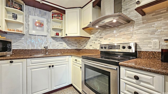 kitchen featuring stainless steel appliances, wall chimney exhaust hood, open shelves, a sink, and tasteful backsplash