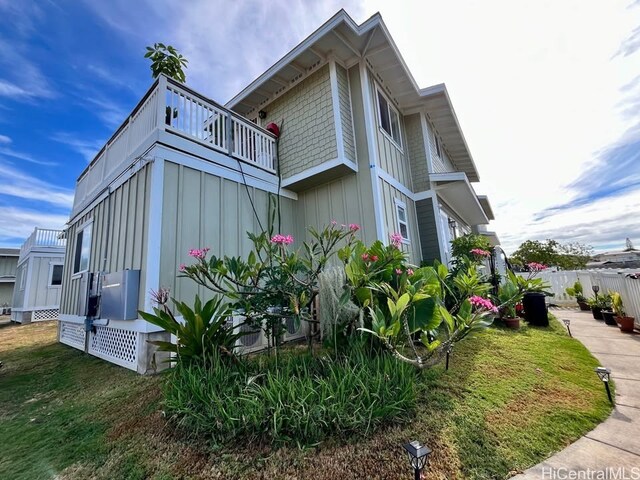view of home's exterior featuring board and batten siding and a balcony