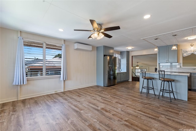 1328 Hele St, Kailua, HI 96734 - kitchen with stainless steel fridge, ceiling fan, gray cabinetry, an AC wall unit, and dark wood finished floors