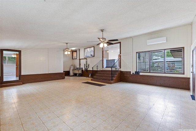1328 Hele St, Kailua, HI 96734 - unfurnished living room with a wall mounted air conditioner, stairs, plenty of natural light, a ceiling fan, and a decorative wall