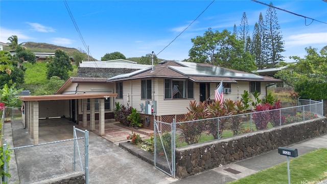 1328 Hele St, Kailua, HI 96734 - bungalow-style home featuring solar panels, driveway, and a carport