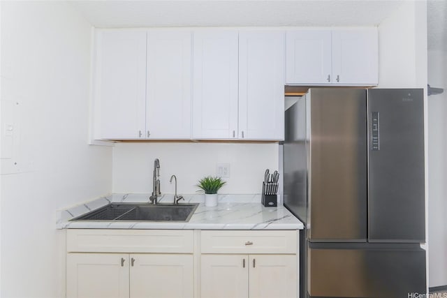 98-1038 Moanalua Rd Unit 1905, Aiea, HI 96701 - kitchen featuring freestanding refrigerator, a sink, white cabinetry, and light stone counters