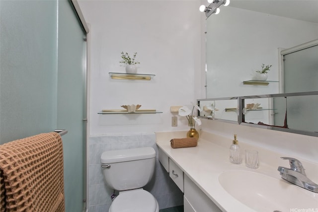 1548 Piikea St, Honolulu, HI 96818 - bathroom featuring toilet, tile walls, vanity, a shower with shower door, and wainscoting