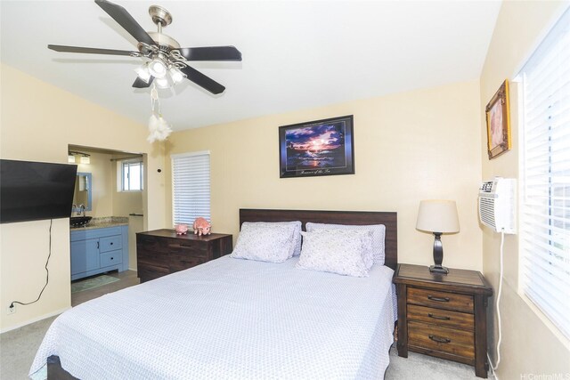 bedroom featuring carpet flooring, a wall mounted air conditioner, lofted ceiling, ceiling fan, and connected bathroom