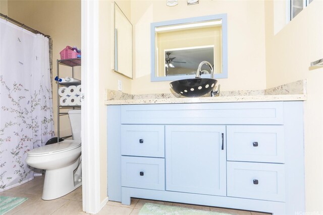 full bath with baseboards, vanity, tile patterned flooring, toilet, and wallpapered walls