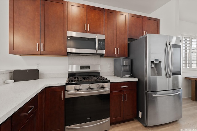 91-1139 Iliahialoe Loop, Ewa Beach, HI 96706 - kitchen with appliances with stainless steel finishes, light countertops, and light wood-type flooring