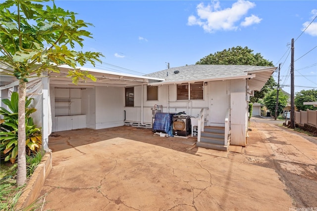 3622 Maunalei Ave, Honolulu, HI 96816 - back of house with an attached carport, a shingled roof, driveway, and fence