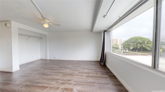 2888 Ala Ilima St Unit 512, Honolulu, HI 96818 - spare room featuring ceiling fan, a textured ceiling, light wood-style flooring, and baseboards