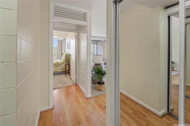 corridor with light wood-style floors