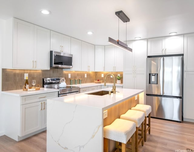 45-630 Liula St, Kaneohe, HI 96744 - kitchen featuring appliances with stainless steel finishes, a sink, light wood-style floors, white cabinetry, and recessed lighting