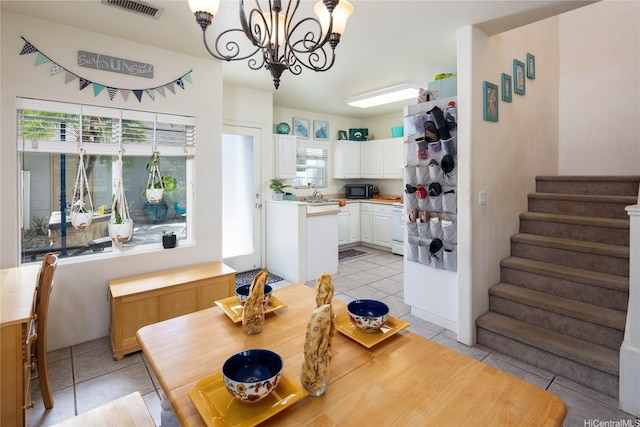 91-1121 Keoneula Blvd Unit L2, Ewa Beach, HI 96706 - dining room with light tile patterned floors, a chandelier, and stairway